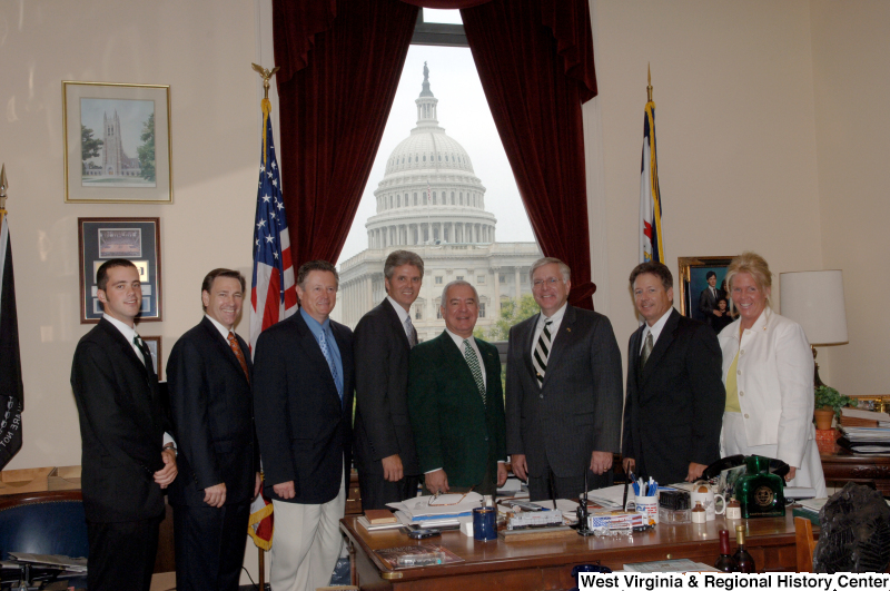 Congressman Rahall stands in his Washington office with six men and one woman.
