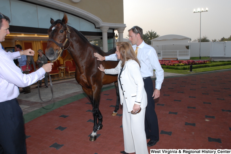 People stand with a horse during a Congressional Delegation trip to Saudi Arabia.