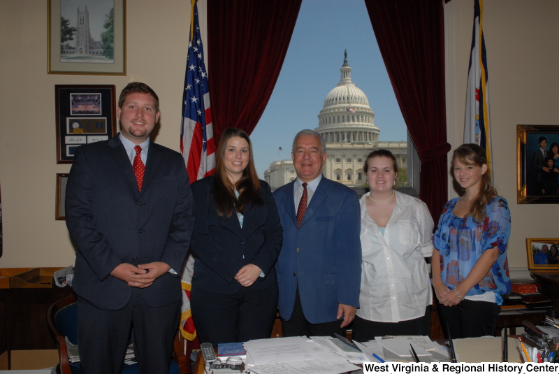 Congressman Rahall stands in his Washington office with a man and three women.