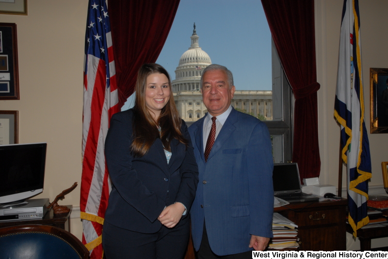 Congressman Rahall stands in his Washington office with a woman wearing a dark blue top and pants.