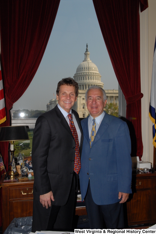 Congressman Rahall stands in his Washington office with a man wearing a dark pinstripe suit.