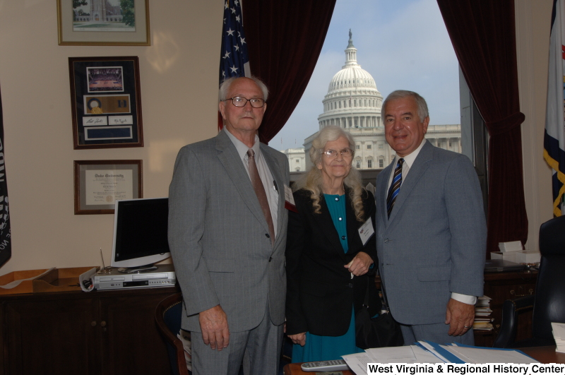 Congressman Rahall stands in his Washington office with Otis and Betty Pence.