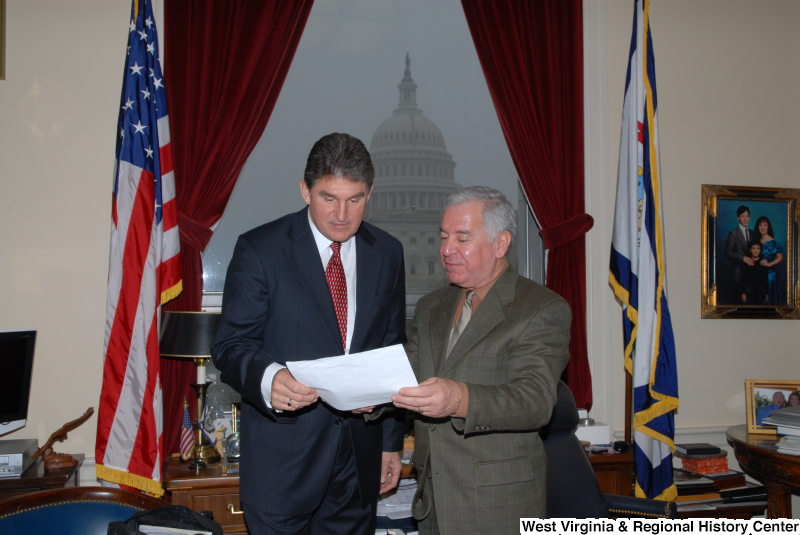Congressman Rahall in his Washington office looks at a document with Joe Manchin III.