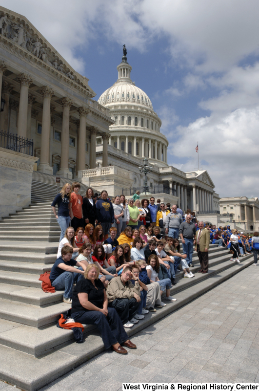 Congressman Rahall stands with a group of people on the steps of the Capitol Building.