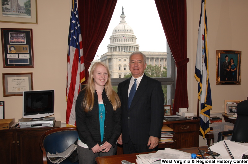 Congressman Rahall stands in his Washington office with a young woman.