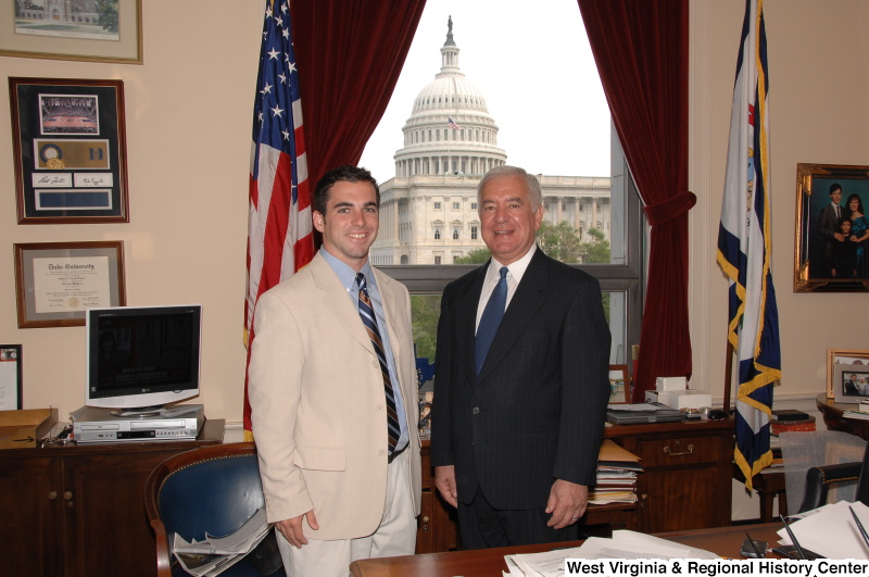 Congressman Rahall stands in his Washington office with a man wearing a tan blazer and striped tie.