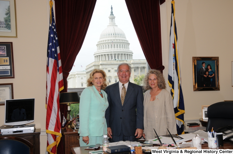 Congressman Rahall stands in his Washington office with two women.