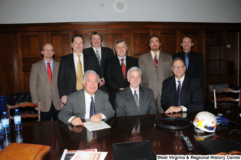 Congressman Rahall sits at a table with eight men.