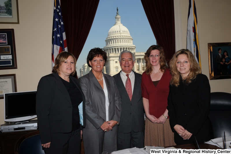 Congressman Rahall stands in his Washington office with four women.