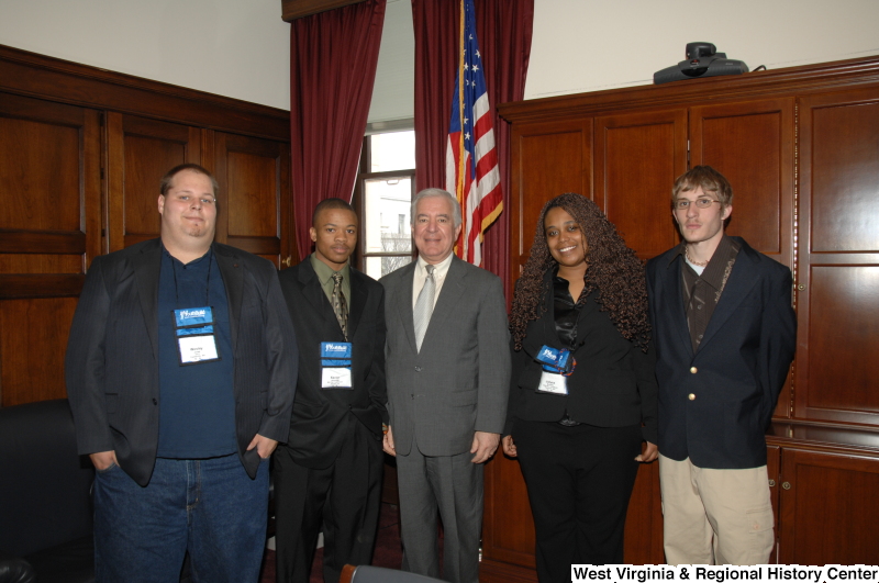 Congressman Rahall stands with four young people wearing YouthBuild name badges.