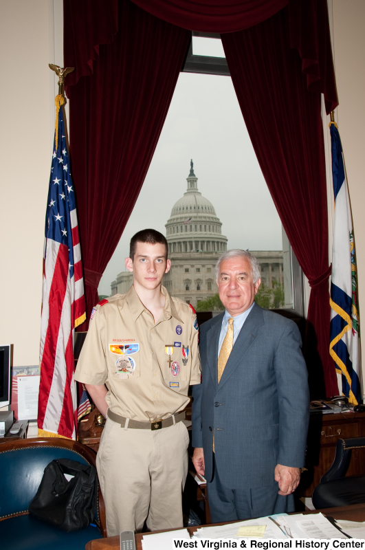 Congressman Rahall stands in his Washington office with a Boy Scout.