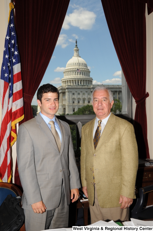 Congressman Rahall stands in his Washington office with a man wearing a light grey suit and gold tie.