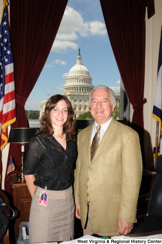 Congressman Rahall stands in his Washington office with an intern wearing a black shirt.