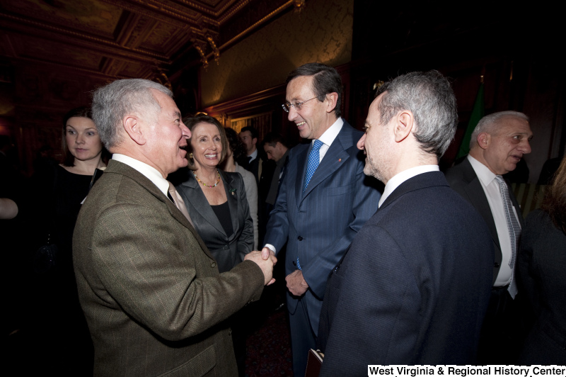 Congressman Rahall shakes hands with a foreign dignitary, accompanied by Nancy Pelosi and others.