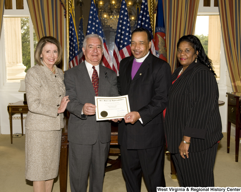 Congressman Rahall and Nancy Pelosi present a certificate to Bishop Fred T. Simms, Heart of God Ministries, Beckley, West Virginia, accompanied by another woman.