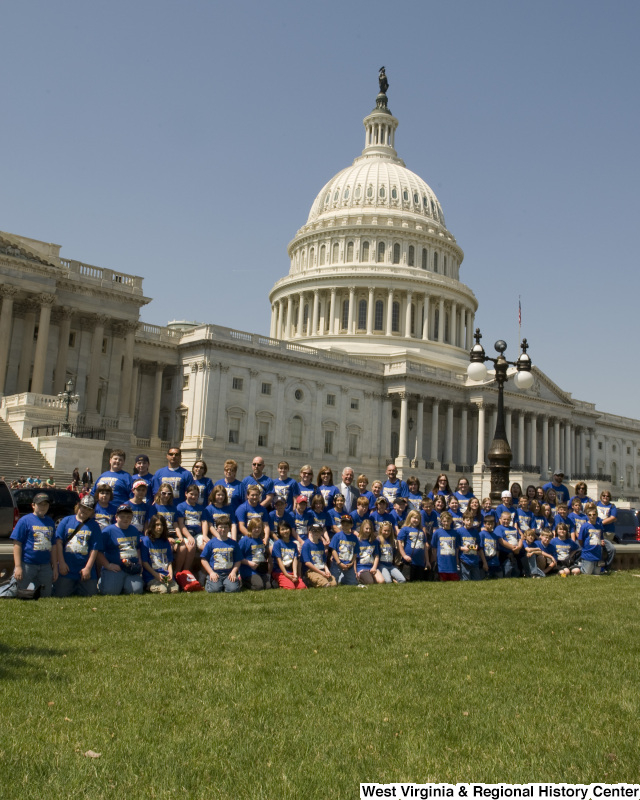 Congressman Rahall stands in front of the Capitol Building with children and adults wearing blue "Bradley" shirts.