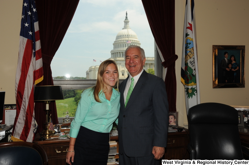 Congressman Rahall stands in his Washington office with a woman wearing a teal shirt.