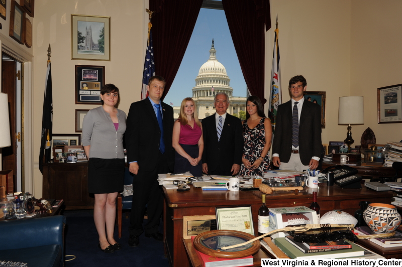 Congressman Rahall stands in his Washington office with two men and three women.