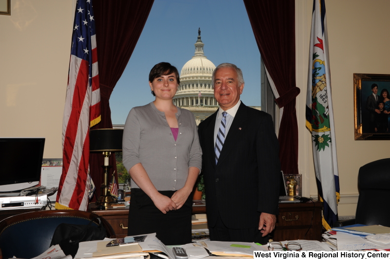 Congressman Rahall stands in his Washington office with a woman wearing a grey cardigan.