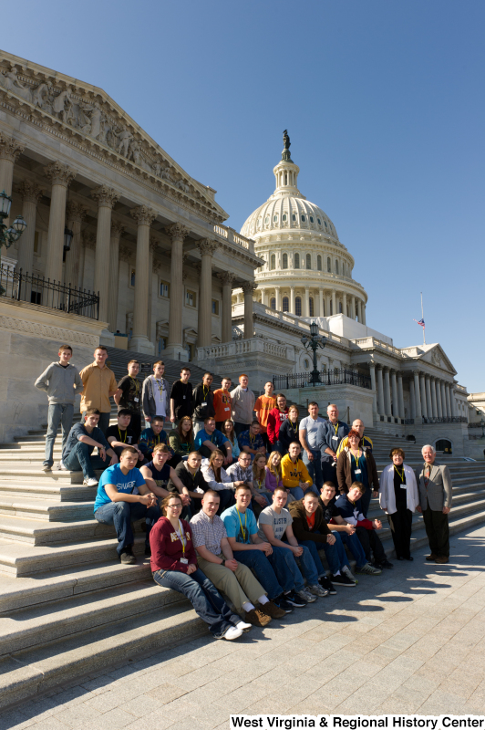 Congressman Rahall stands on the steps of the Capitol Building with teenagers and adults.