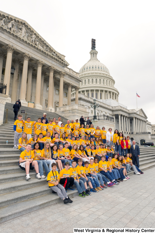 Congressman Rahall stands on the steps of the Capitol Building with children and adults wearing yellow "Bradley Goes to D.C." shirts.