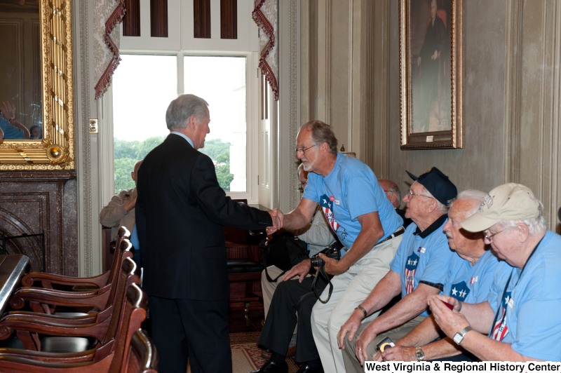 Congressman Rahall shakes hands with men at a military award ceremony.