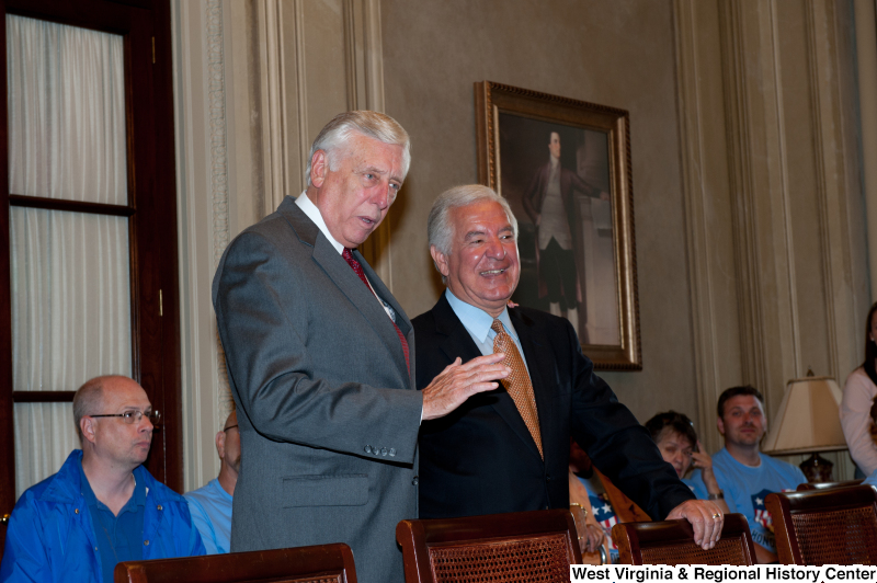 Congressman Rahall and another man speak to veterans at a military award ceremony.