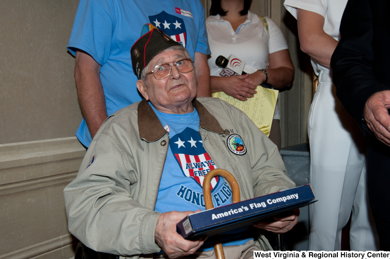 Andrew Semonco, World War II veteran, receives a certificate at a military award ceremony.