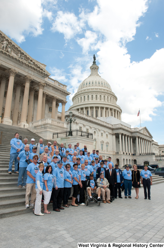 Congressman Rahall stands next to veterans on the steps of the Capitol Building.