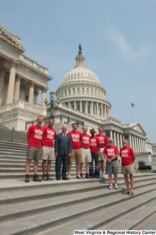 Congressman Rahall standing on the steps of the Capitol Building with men wearing red shirts labeled "RIDING FOR OUR HOMELESS VETS: Huntington WV to Washington DC".