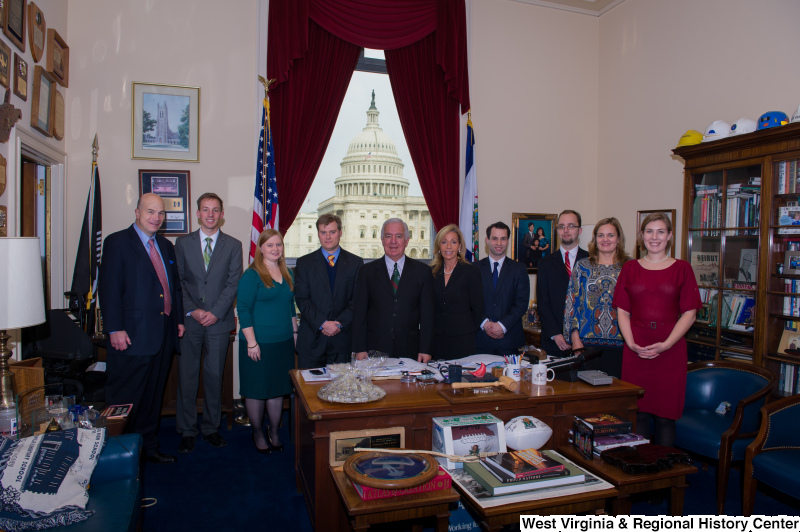 Congressman Rahall stands in his Washington office with nine other people.