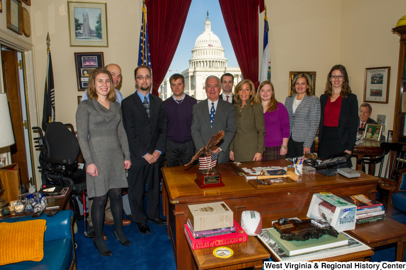 Congressman Rahall stands with a group of nine people in his Washington office.