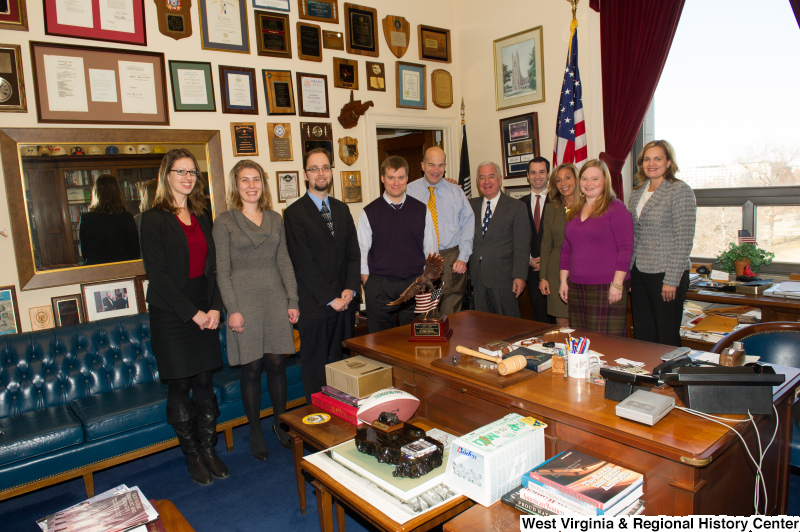 Congressman Rahall stands in his Washington office with nine people.