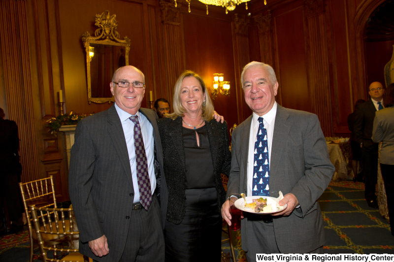 Congressman Rahall stands with a man and a woman at a reception.