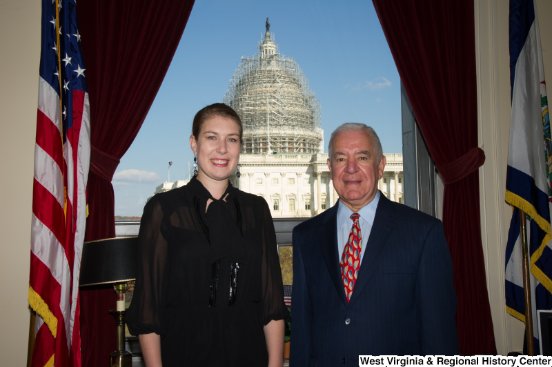 Congressman Rahall stands in his Washington office with a woman wearing a black outfit.