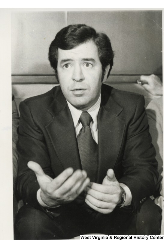 Photograph of Congressman Nick Rahall in Beirut, Lebanon. Photo taken at an airport press conference upon departure of Beirut to Damascus, Syria. Rahall is responding to questions on his visit with Chairman Yasser Arafat of Palestine Liberation Organization (PLO).