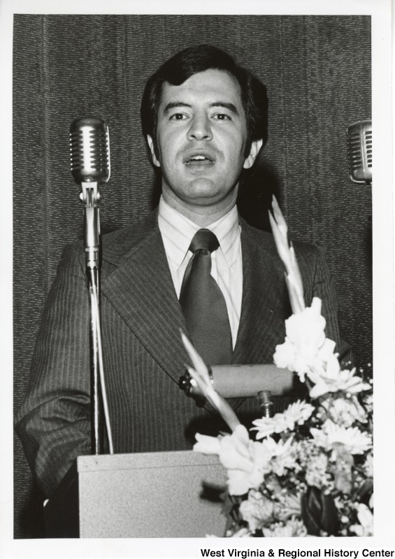 Congressman Nick Rahall II standing at a podium speaking to an unidentified audience.