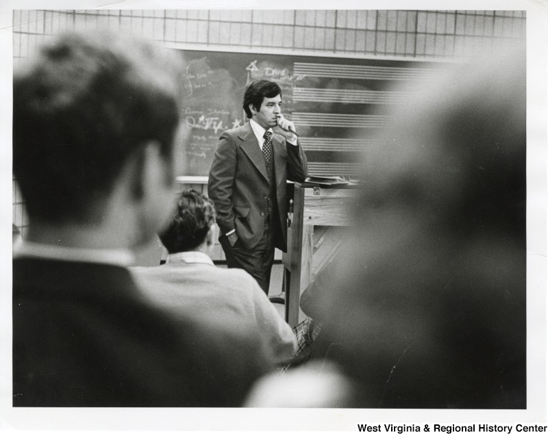 Congressman Nick Rahall II standing in front of a group of people at a town hall meeting in an unidentified location.