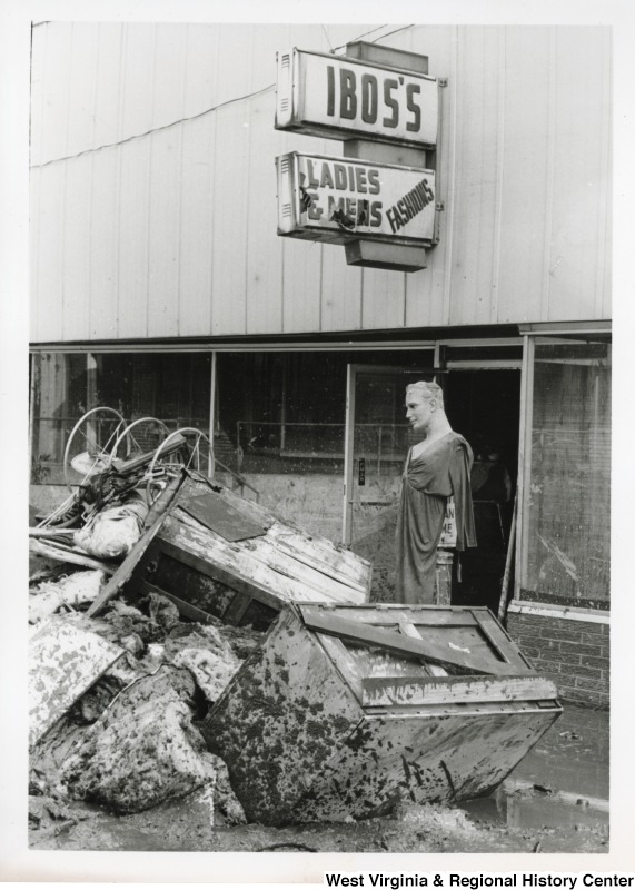 A photograph of flood damaged materials in front of Ibos's Ladies & Mens Fashions in Mingo County.