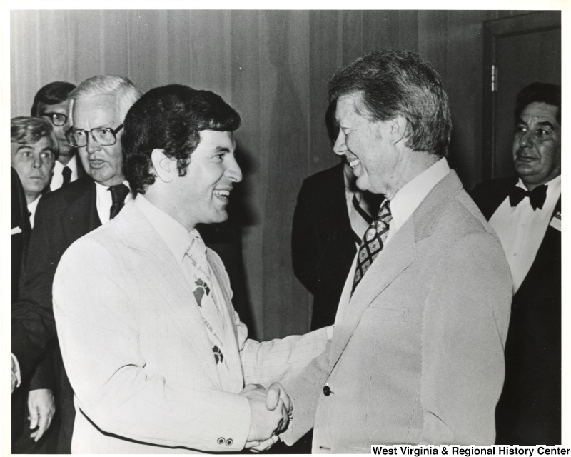 Congressman Nick Rahall II shaking the hand of President Jimmy Carter.