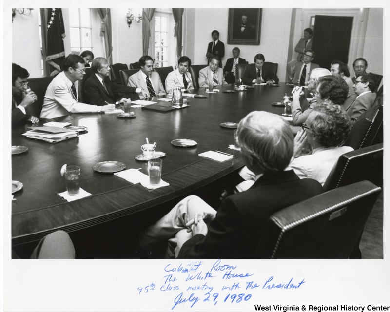 From left to right: Congressman Leon Panetta (D-CA), Congressman Ike Skelton (D-MO), President Jimmy Carter, Congressman Dan Glickman (D-KS), Congressman Nick Rahall II (D-WV), Congressman Cecil Heftel (D-HI), Congressman Al Gore (D-TN), coming through the door is Frank Moore a congressional liaison, Congressman Don Pease (D-OH), Congressman Mary Rose Oakar (D-OH), Congressman Tony Beilenson (D-CA), Congressman Jerry Huckaby (D-LA), Congressman Ed Jenkins (D-GA), Congressman Charles Whitley (D-NC), Congressman Ronnie Flippo (D-AL), Congressman Wyche Fowler (D-GA), and Congressman Dick Gephardt (D-MO).