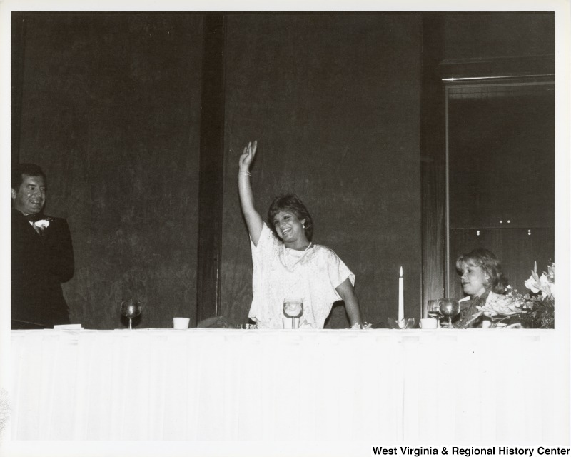 Olympic medal winner Mary Lou Retton waving. Congressman Nick Rahall II is standing to her right (left side of the photo).