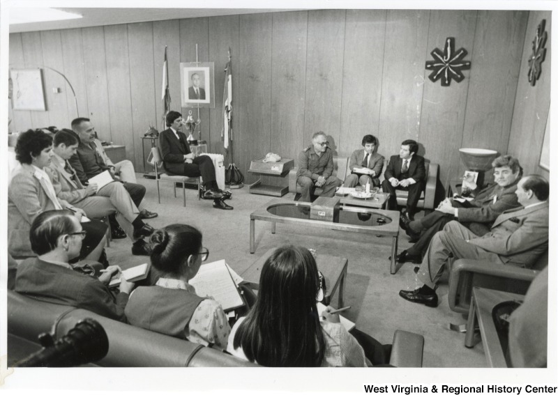 Congressman Nick Rahall, Congressman Bob Carr, Congressman Toby Moffett, General Khoury, commander of the Lebanese Army and a room full of people. From left to right: Congressman Bob Carr (In the back left seated in a chair by himself). On the couch in the back: General Khoury, Congressman Toby Moffett, and Congressman Nick Rahall II. The rest of the individuals are unknown.