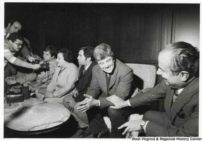 From left to right: Congressman Bob Carr (D-MI) who is hidden by the arms of the press, Congressman Toby Moffett (D-CT), Congresswoman Mary Rose Oakar (D-OH), Congressman Nick Rahall II (D-WV), Congressman Pete McCloskey (R-CA), and the Chairman of Lebanon's Public Works Committee. The Congressmen are being interviewed by the press upon their arrival at the Beirut airport.