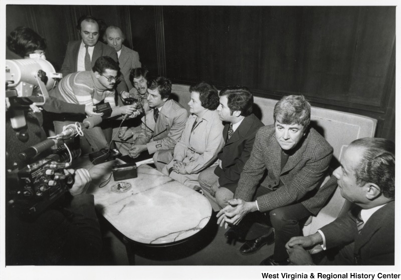 Seated from left to right: Congressman Bob Carr (D-MI), Congressman Toby Moffett (D-CT), Congresswoman Mary Rose Oakar (D-OH), Congressman Nick Rahall (D-WV), and Congressman Pete McCloskey (R-CA). They are being interviewed upon their arrival at the Beirut International Airport.