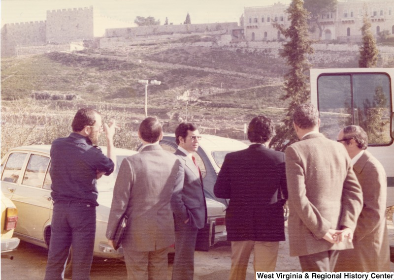 From left to right: an unidentified Israeli escort; Jim Collins, U.S. State Department escort; Congressman Nick Rahall; Congressman Toby Moffett; and an unknown Israeli escort. They are at Mishkenot Sha'ananim, an artist area, for breakfast with the Mayor of Jerusalem, Teddy Kolleck.