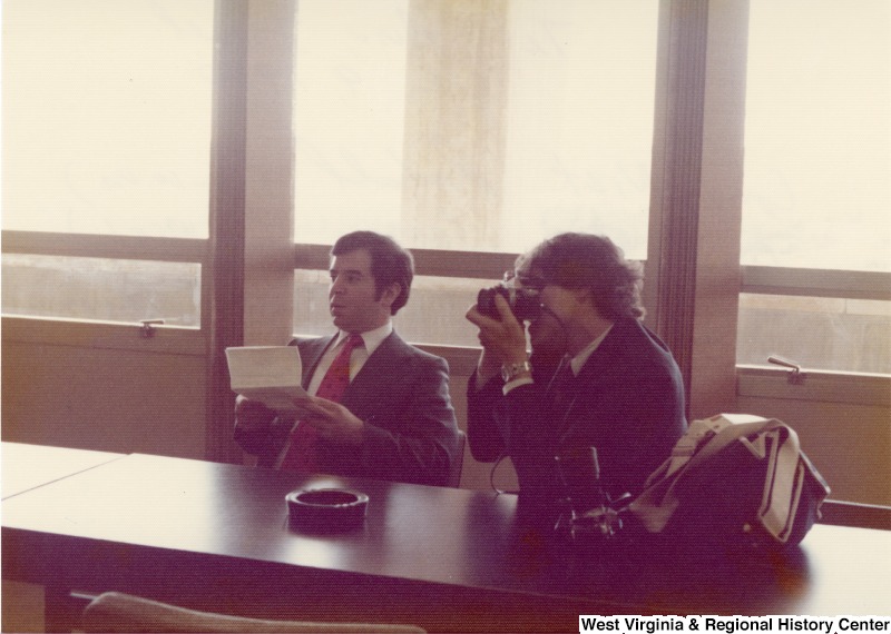 Congressman Nick Rahall and Congressman Bob Carr meeting in Shimon Peres of the Labor Alignment Party's office. Congressman Carr is taking a photograph.