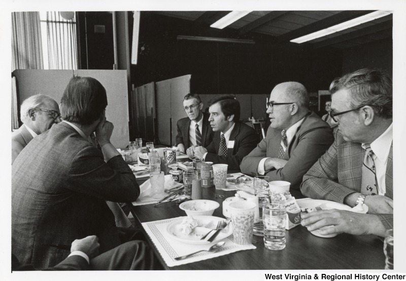 Congressman Nick Rahall II (third from the left) having a lunch with five unidentified men.