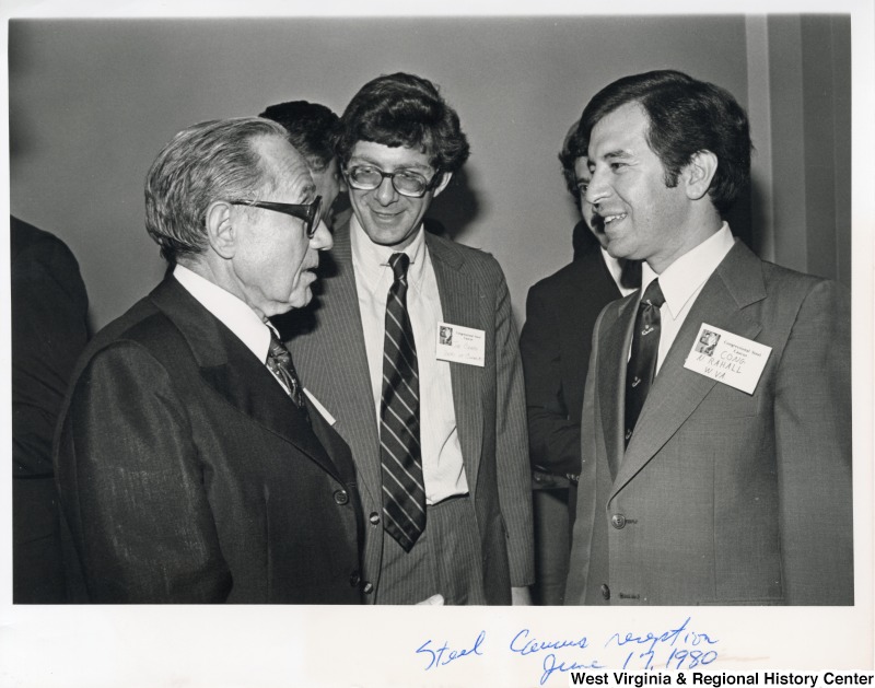 Congressman Nick Rahall II (right) speaking to Joe Crapa (center) of the Department of Commerce and an unidentified man.