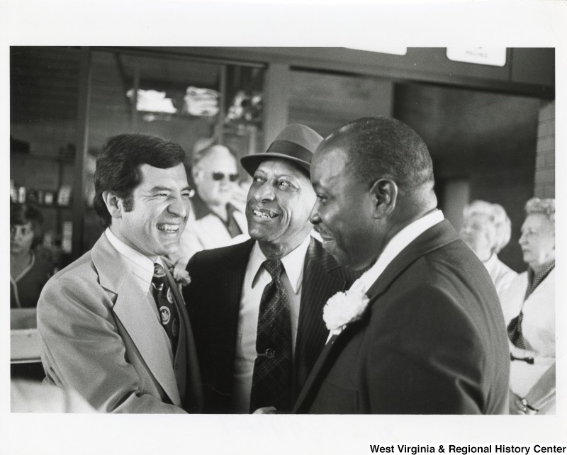 Congressman Nick Rahall II (left) with two unidentified men.